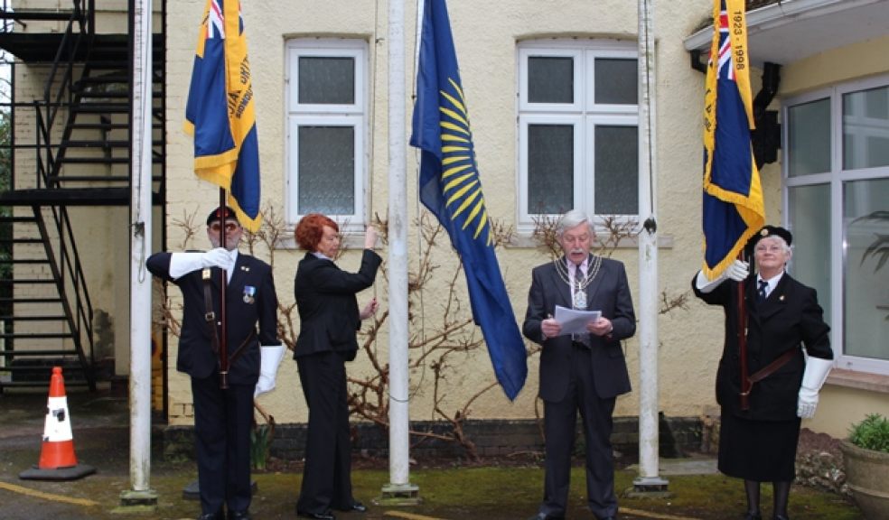 Our picture shows EDDC Chairman Councillor Graham Godbeer reading the affirmation as the flag is raised by Vice-Chairman Councillor Christine Drew, flanked by Royal British Legion standard bearers