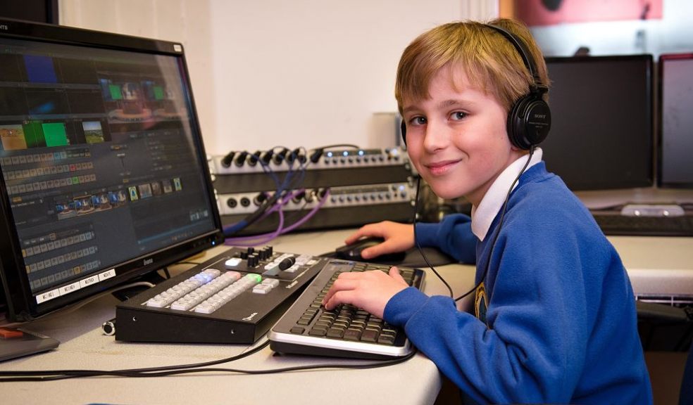 Year 4 BCPS student using desktop computer and headphones