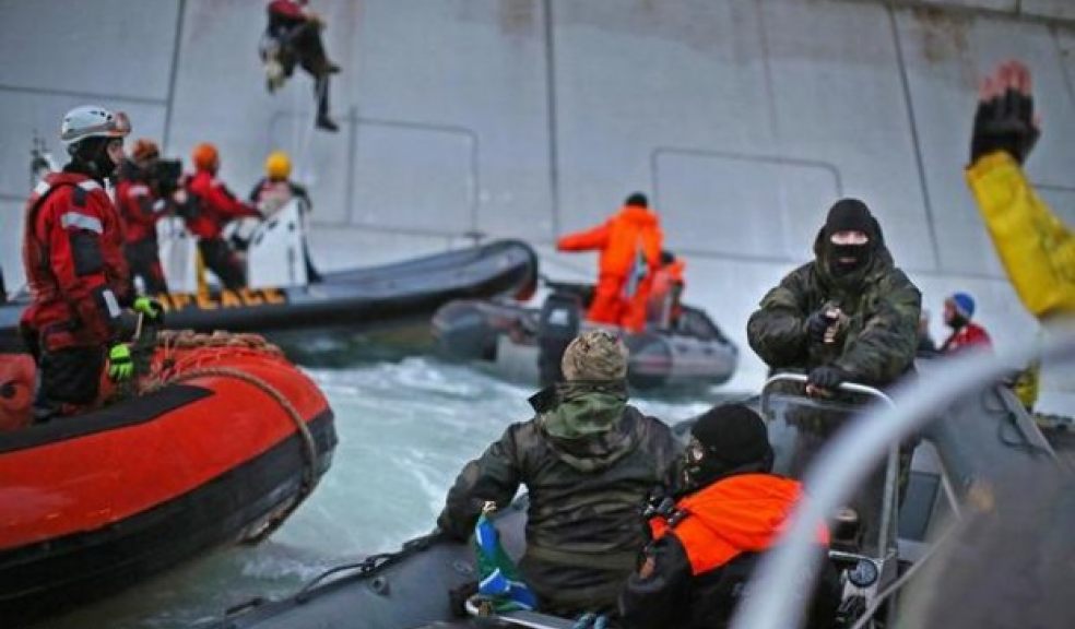 Balaclava wearing men make arrest at gunpoint. pictures courtesy of Greenpeace