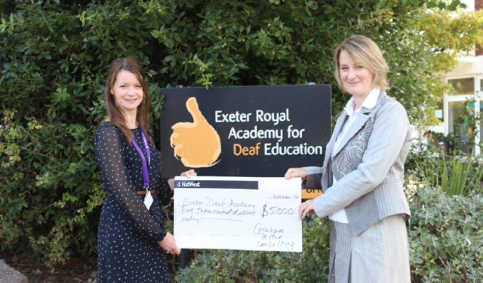L-R: Tori Webb, Community and Corporate Fundraising Manager from Exeter Deaf Academy is presented with the cheque from Susie Hills, UK Managing Director of Graham-Pelton Consulting outside the Deaf Academy