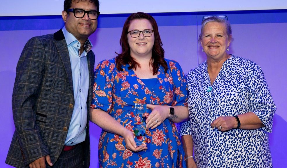 Hailei onstage accepting her award. Pictured is Paul Sinha (Host) and Tanya Pretswell (UNISON).