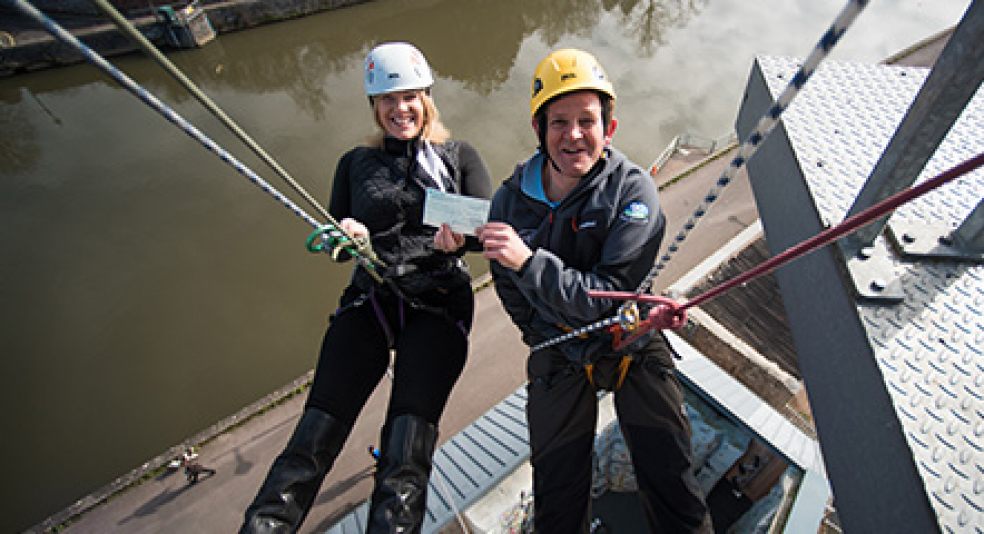 Award sponsor Charlotte Bosworth hands over the £5,000 prize cheque to Ben Hedden at the top of the climbing tower. Photo courtesy of Devon County Council