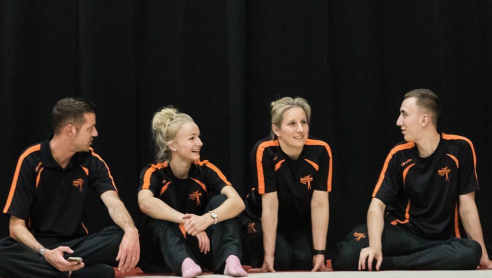 Helen (middle right) with a team of her coaches at a recent gymnastics competition.