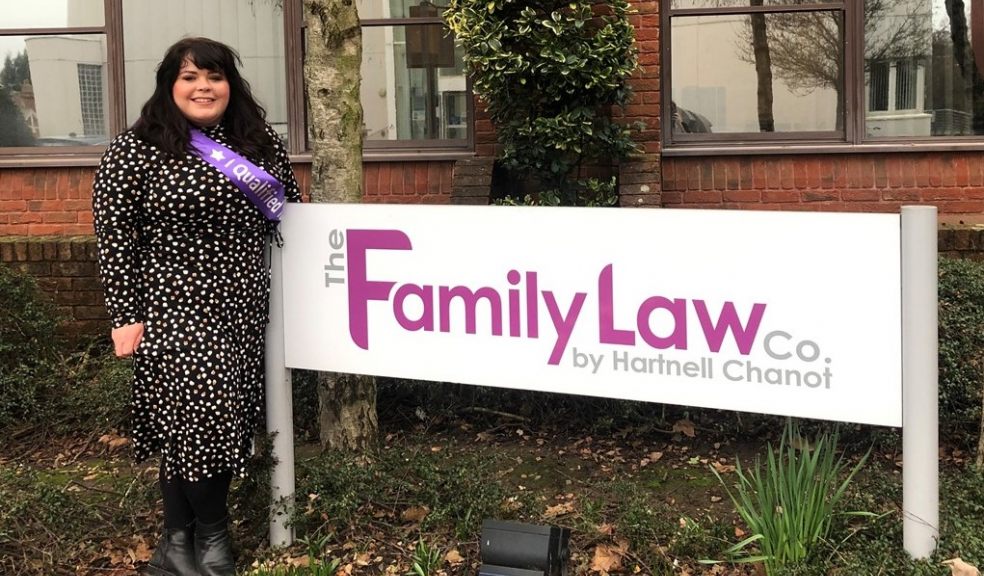 Woman standing by sign