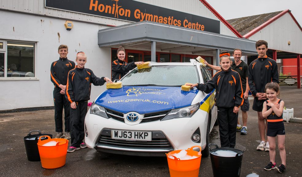 Honiton Gymnasts and Johnny Bennett from the club's Supporters Association (back right) get ready for their car-washing event on Saturday 9 June