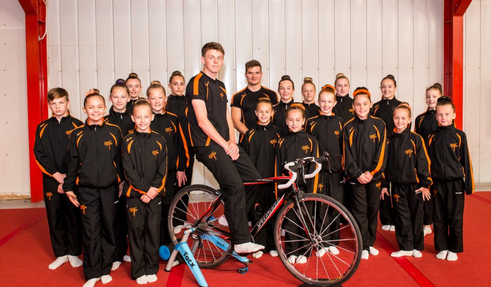 Honiton Gymnasts, attending the Turin International Acro Cup & Lisbon International Acro Cup. Centre (on bike) is Reece Cutler, 15, one of the gymnasts riding through the night to raise money for the trips