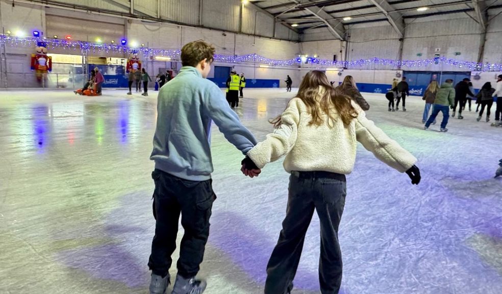 two teenagers ice skating on ice rink