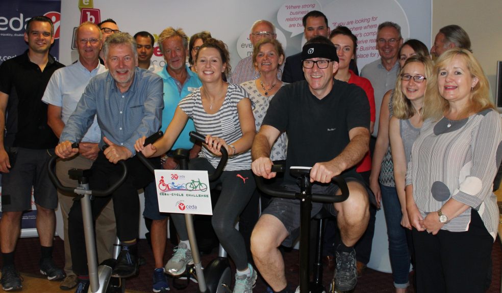 Exeter Business Club members egging on their cycling colleagues, left to right, Pete Weeks, Tiffany Beard and Chris Robson to help raise money for CEDA.