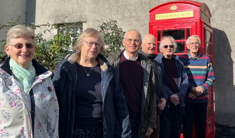 - Topsham Museum’s telephone box team pictured at the box on Fore Street, Topsham