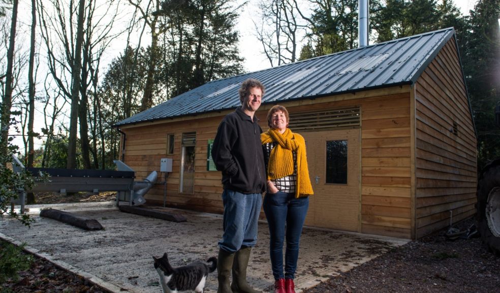 Jean Michael and Lucy Kennaway in front of the biomass boiler house, designed and built by SunGift Energy