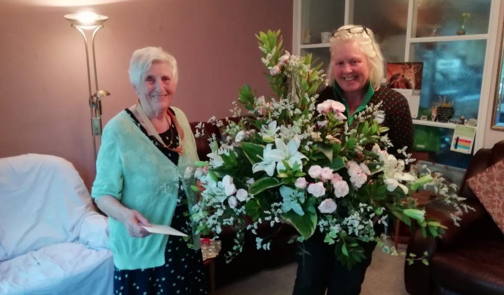 Deborah Custance Baker from Devon County Show (right) presents a bouquet of 90 stems to Joan Mitchell who celebrated her 90th birthday earlier this week