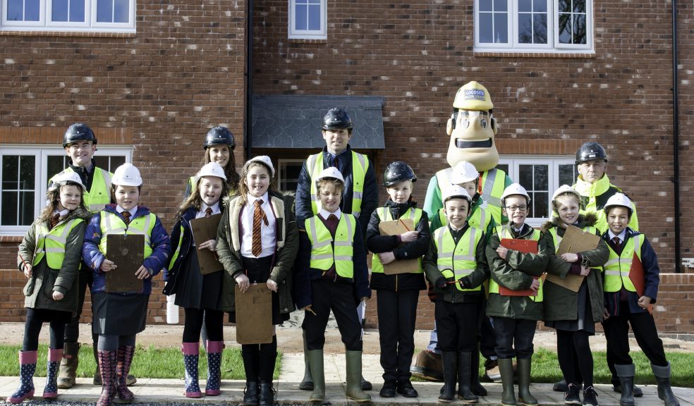 The first group of pupils infront of the show home on site with (L-R) Mike Crawford (Head of Construction) , Gemma Smith (Sales & Marketing), Simon Westwood (Head of Teaching & Learning - Lady Seawards) , Ivor Goodsite (Construction man costume) and Marinko Tomic (Site Manager)
