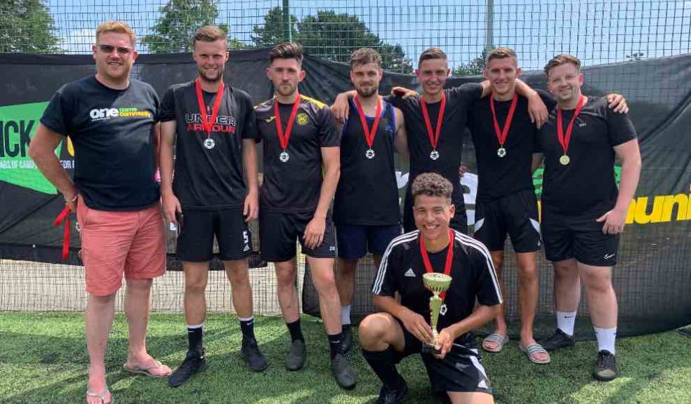 Marcel's Allstars, men's winners of the Exeter City FC One Game One Community Group community diversity football tournament, with Simon Kitchen from ECFC OGOC group, left. Photo: Alan Quick