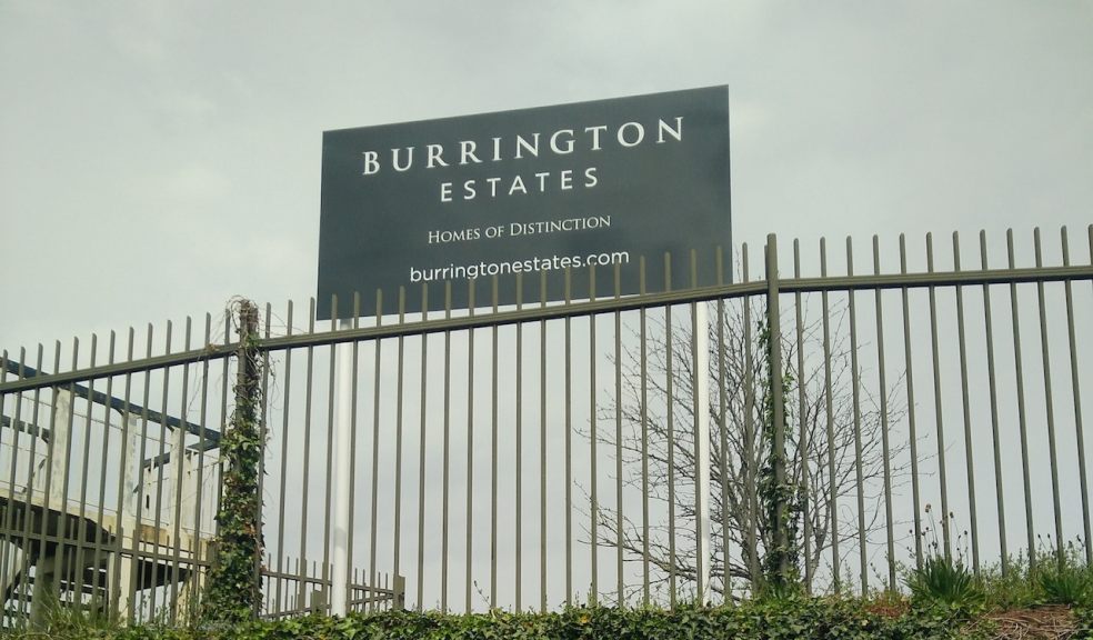 Burrington Estates Sign on the Topsham Road Playing Field Sign saying Burrington Estates, Homes of Distinction