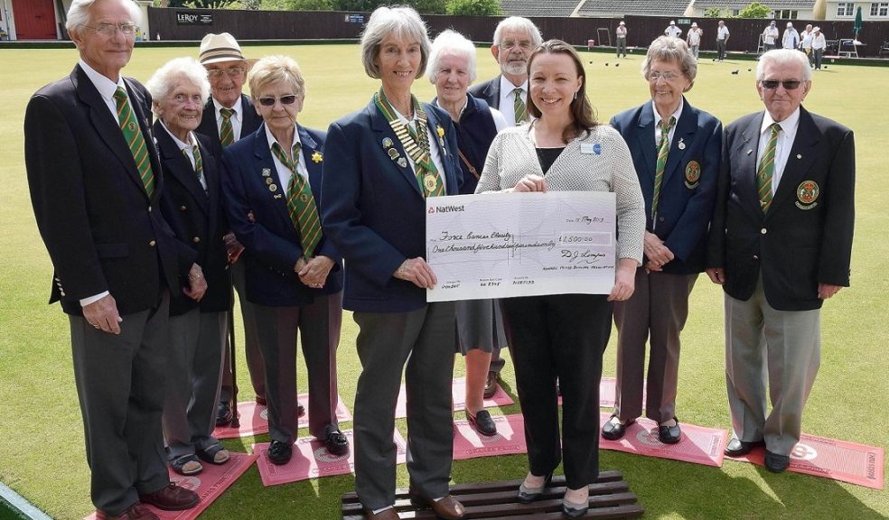 Nomads bowlers present a cheque for £1,500 to FORCE Cancer Charity