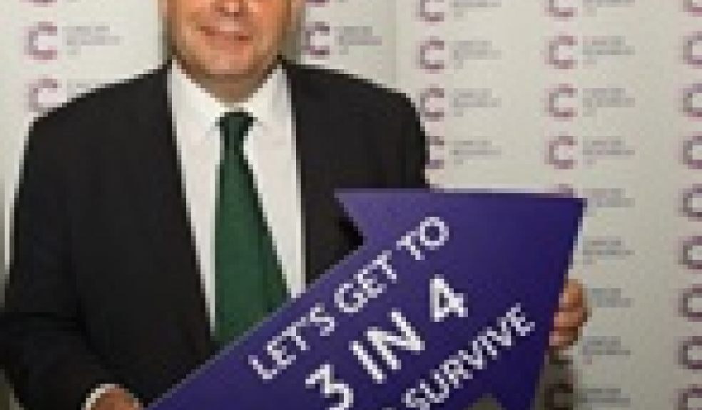 Tiverton and Honiton MP Neil Parish holds an arrow with the words ‘LET’S GET TO 3 IN 4 WHO SURVIVE’. This represents Cancer Research UK’s ambition to boost the number of people surviving cancer from two in four today, moving to three in four within the next 20 years.