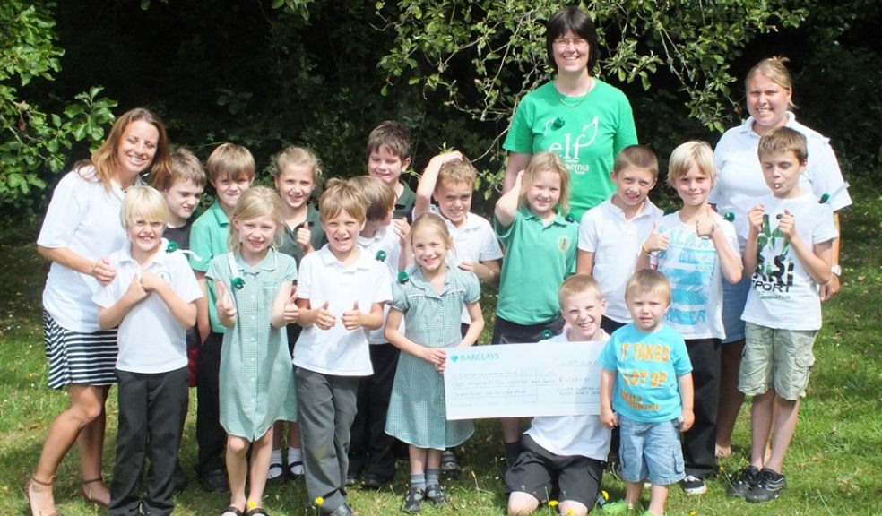 Class 3 ,North Tawton Primary School presenting the cheque to Bridget Hill, ELF's Fundraising Manager.