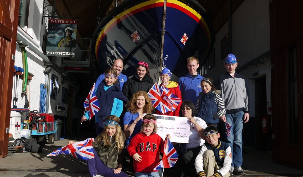 Children and staff from Splash Swim School, Exeter present their cheque to Caz Ashman from Exmouth RNLI