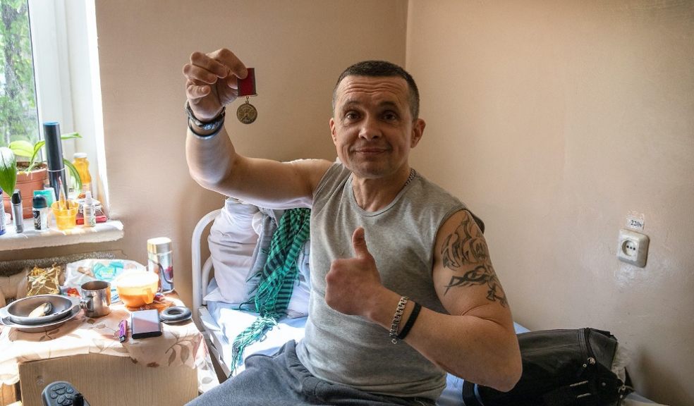 A Ukraine veteran injured in fighting in the east of Ukraine proudly show his campaign medal. Photo: Perou.