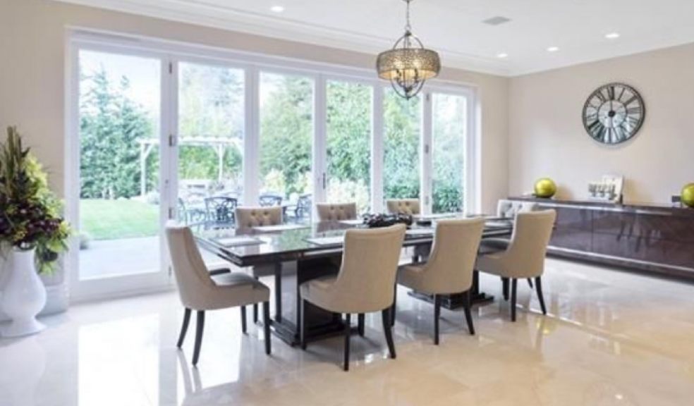 A living room filled with furniture and a large bi fold door