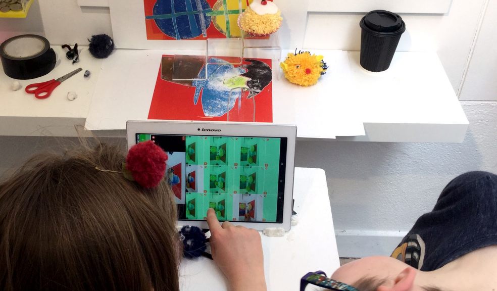 Kids filming hand made pom poms at Devon Guild