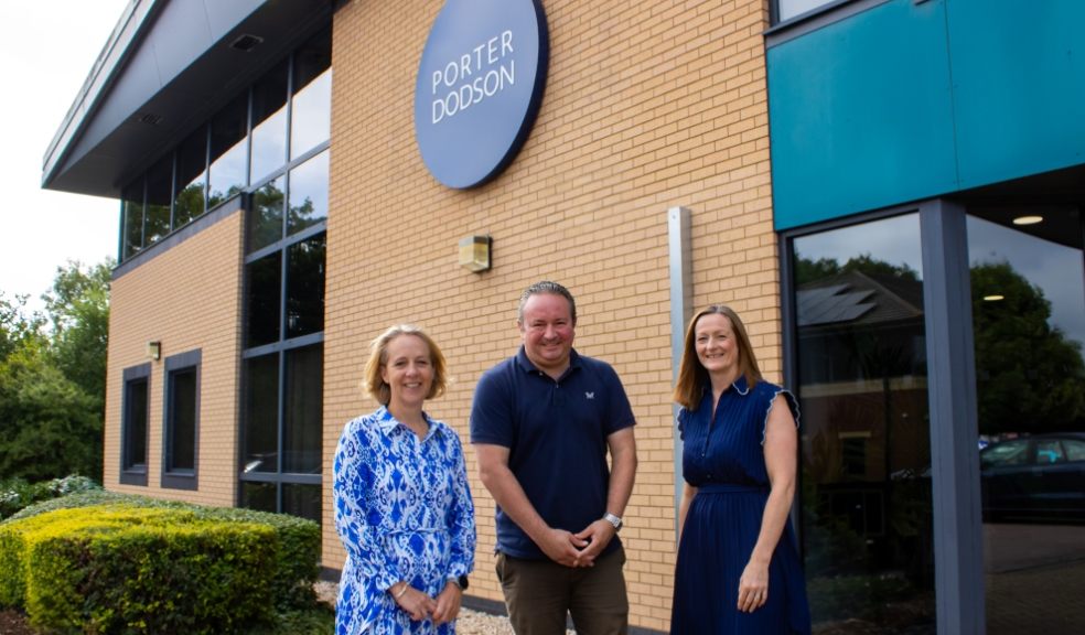 Exeter-based law firm achieves record breaking results Porter Dodson building with three members stood in front