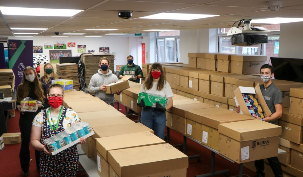 Staff from Exeter City Community Trust and volunteers pack up parcels at St James Park Staff from Exeter City Community Trust and volunteers pack up parcels at St James Park