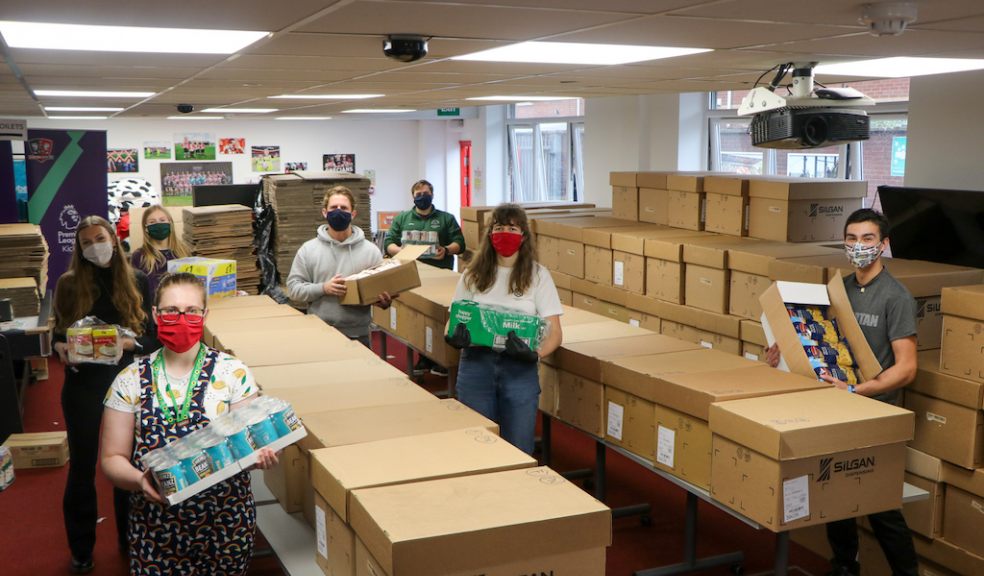 Staff from Exeter City Community Trust and volunteers pack up parcels at St James Park