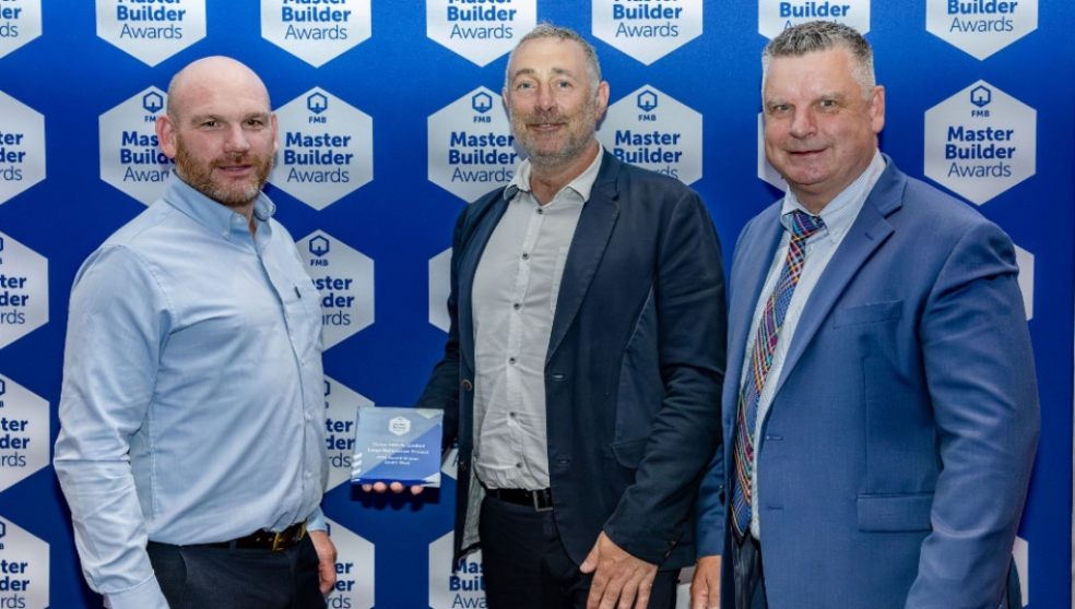Christian Dally and Ross Pollard collecting the award from Richard Lindop from Northern Building Plastics Ltd