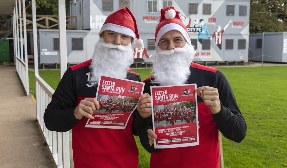 Exeter City FC first team players Matt Jay and Pierce Sweeney take time out of their training schedule to help promote the CITY Community Trust Santa Run Exeter City FC first team players Matt Jay and Pierce Sweeney take time out of their training schedule to help promote the CITY Community Trust Santa Run