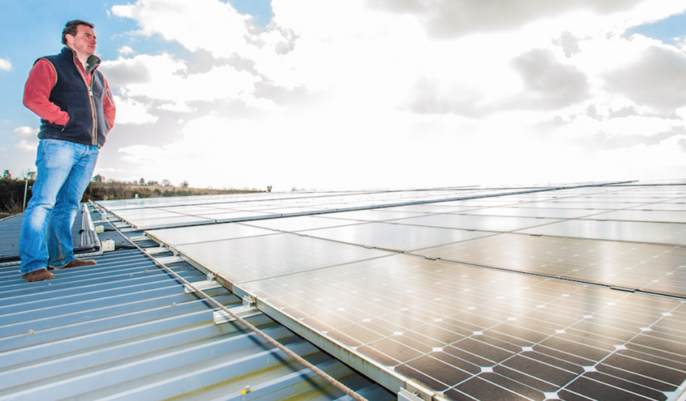 Paul Dart on the roof of Darts Farm with some of the solar PV panels that were installed by Exeter’s SunGift Energy