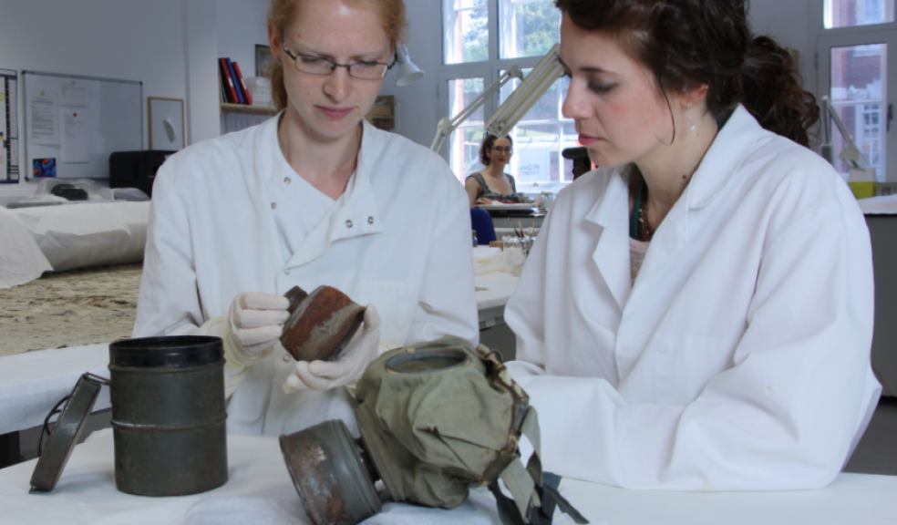 The gas mask being conserved by RAMM Conservator Sarah Klopf and student Hana Bristow © 2015 Royal Albert Memorial Museum & Art Gallery, Exeter City Council