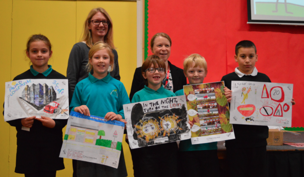 Assistant Headteacher Claire McKimm (left) and Lindsey Connett of Foot Anstey (right) are shown with Stoke Hill’s Road Safety Week prize-winners and their designs.