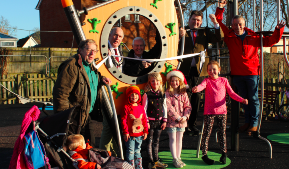 L-R: Cllr Simon Pollentine (Sidmouth Town Council), Cllr Stuart Hughes (Chair EDDC & Sidmouth Sidford ward member, Cllr Jeff Turner (Chair of STC), Cllr Iain Chubb (EDDC environment portfolio holder), Cllr Ian Barlow (STC) with local children from Sidford