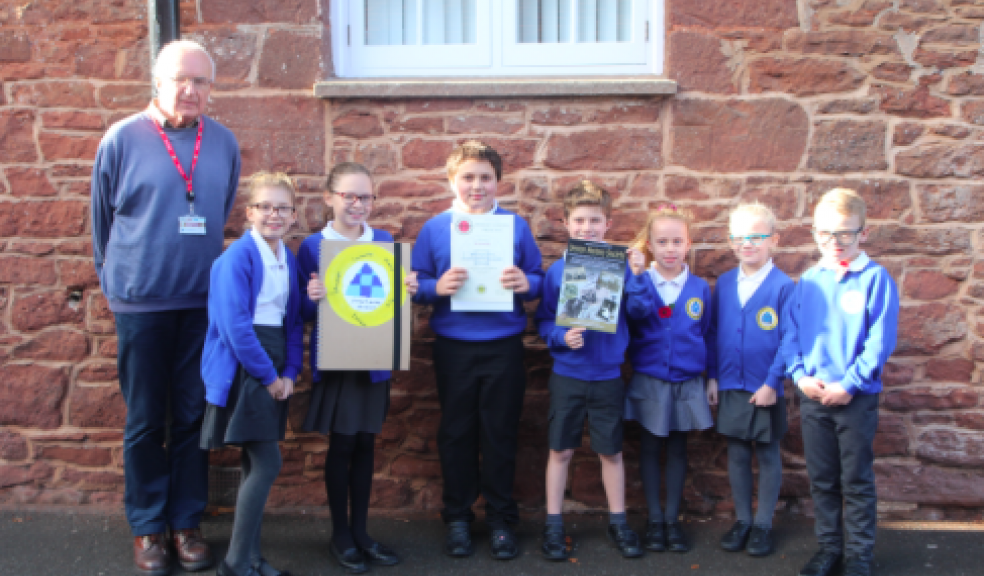 Andrew Jones, chairman of the society, with l-r Emily Bunday, Esme Turner, Reggie Callaway, Luke Schneeberger, Ellen Somerwill, Ella Gifford, Harley Ewings