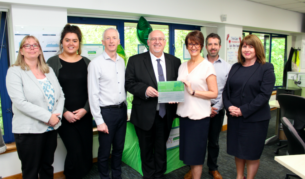 South West Water's Managing Director, Stephen Bird, accepting the prestigious customer service award alongside the customer service team
