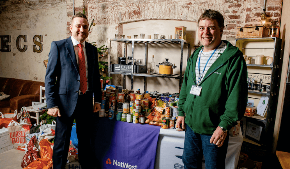 James Court, NatWest Business Growth Enabler for Mid and East Devon (left) with Mark Richardson, Exeter Foodbank Manager and the hundreds of food items donated by local businesses