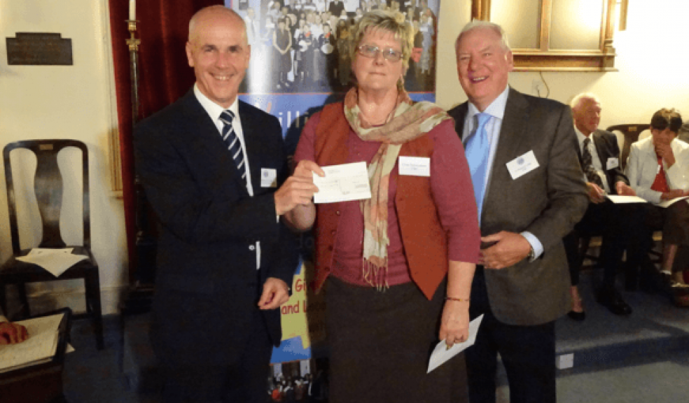 Philippa May receiving a cheque for £1000 from Nicholas Ball accompanied by Bro. Bob Buckley