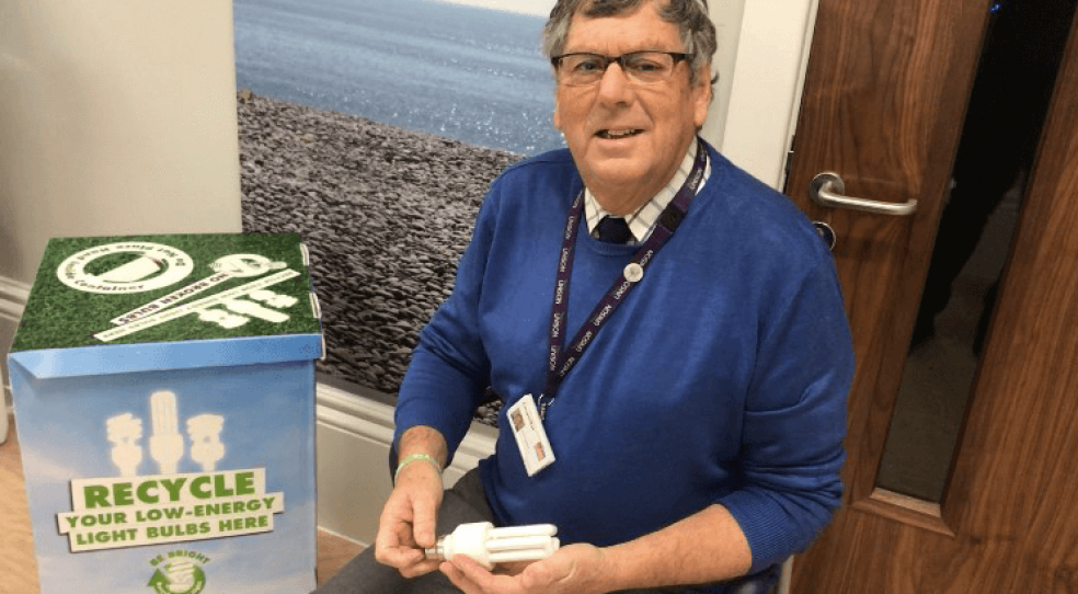 Cllr Gazzard with a collection box to recycle light bulbs.