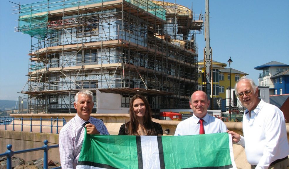 L to R Chris Fayers, Joanna Hole, Chris Baxter and Ian Dowelll hold the flag with Spinnakers in the background