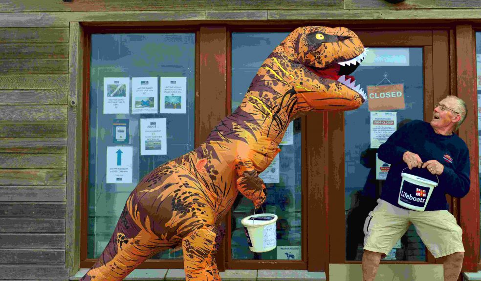 Mr T Rex puts the frighteners on Exmouth RNLI’s Visits Officer, Bill Lodge, just before he embarks on his long journey. Credit : John Thorogood / Exmouth RNLI