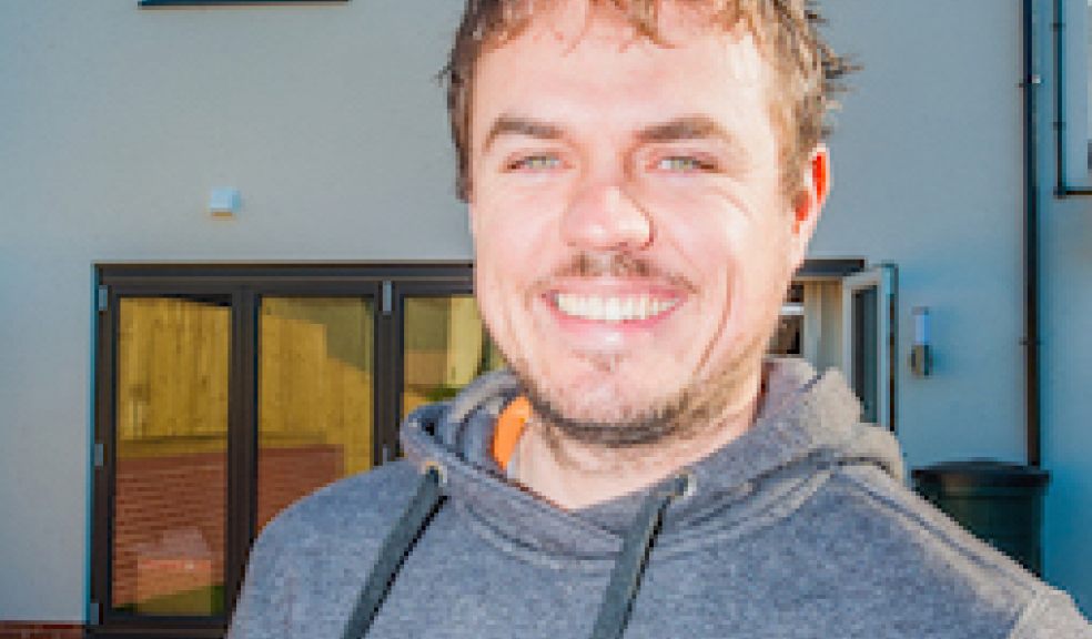 30-year-old Tyrone France in front of his solar PV system