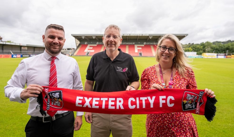 Pictured are, L-R, Tom Wenborn (ECFC) with Duncan Worthington and Hannah Barnard from Taking Care. Pictured are, L-R, Tom Wenborn (ECFC) with Duncan Worthington and Hannah Barnard from Taking Care.