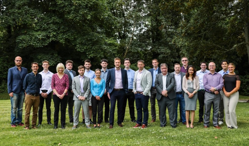 group of men and women from Timewade standing on green grass 