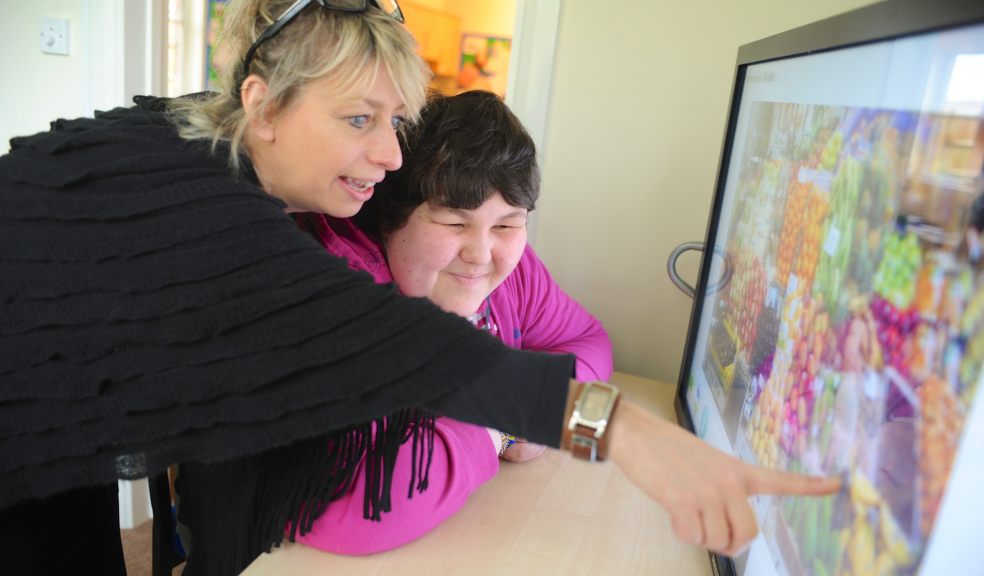 WESC Foundation staff member Jane helps learner Jade with specialist visual impairment equipment