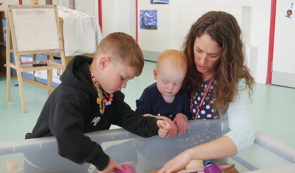 Westbank's Kidzone Manager Lucy Elliott with two of the preschoolers in her care