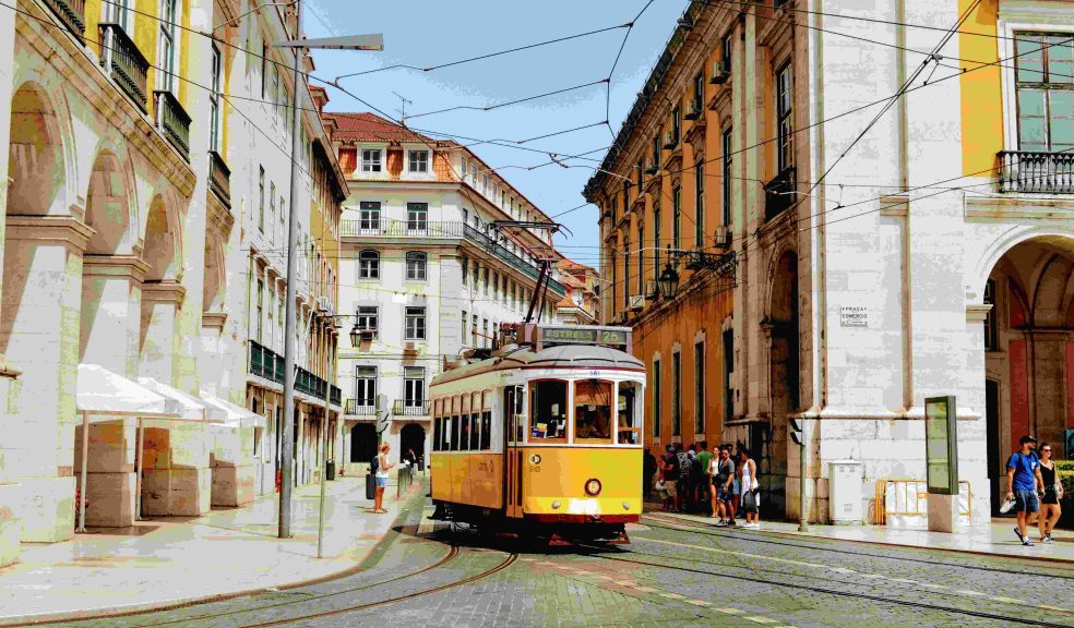 Iconic yellow tram going through Lisbon