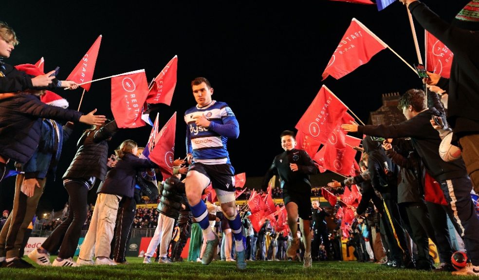 Rugby players running out onto rugby pitch