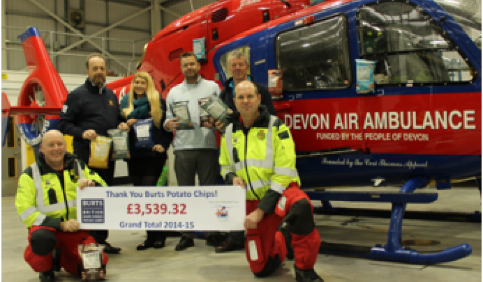 David Nairn, Managing Director Burts Chips, and Laura Murch, Marketing Assistant Burts Chips, present the cheque to Devon Air Ambulance paramedics Adrian Parker (left) and Richard Walker (right)