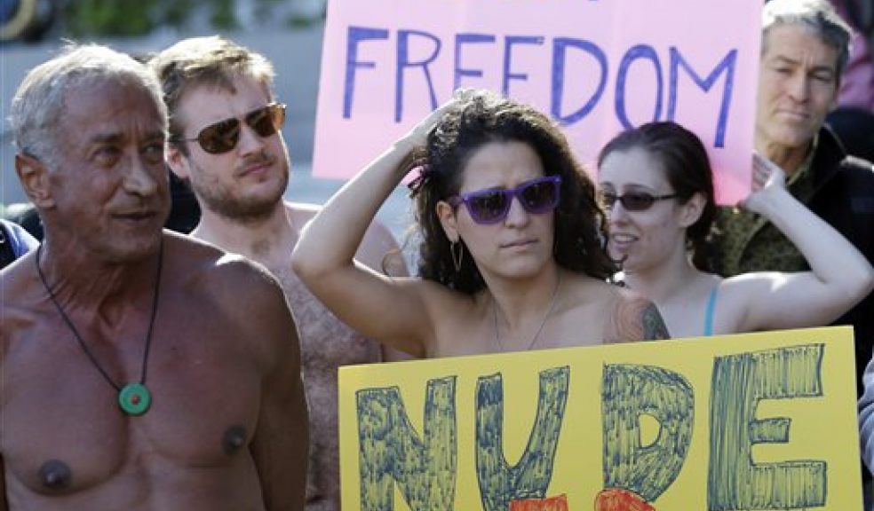 Demonstrators gather outside of City Hall in San Francisco for a protest against a proposed city-wide nudity ban, Wednesday, Nov. 14, 2012. San Francisco appears poised to shed part of its image as a city where anything goes, including clothing. The Board of Supervisors is scheduled to vote next week on a law that would ban public nudity. The proposal comes in response to a devoted group of nudists who proudly strut their stuff through the city's Castro District. (AP Photo/Marcio Jose Sanchez)
